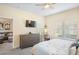 Bright bedroom with large window, ceiling fan, and gray dresser at 1161 Trappers Trail Loop, Davenport, FL 33896