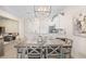 Cozy dining area with modern lighting and seating adjacent to an open kitchen with stainless steel appliances at 1161 Trappers Trail Loop, Davenport, FL 33896