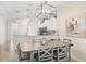 Cozy dining area open to the kitchen, featuring a rustic table, and pendant lighting at 1161 Trappers Trail Loop, Davenport, FL 33896