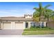Inviting exterior showcasing a landscaped yard, well-maintained lawn, and two-car garage at 1161 Trappers Trail Loop, Davenport, FL 33896