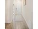 Bright hallway featuring modern gray tiling, leading to a front door and other rooms in the home at 1161 Trappers Trail Loop, Davenport, FL 33896