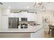 Open kitchen design featuring stainless steel appliances, quartz countertops, and white cabinets at 1161 Trappers Trail Loop, Davenport, FL 33896
