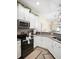 Bright kitchen featuring sleek countertops, stainless steel appliances, and ample cabinetry at 1161 Trappers Trail Loop, Davenport, FL 33896