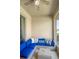 Cozy lanai features a comfortable blue cushioned seating area and a glass topped coffee table at 1161 Trappers Trail Loop, Davenport, FL 33896
