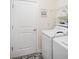 Bright laundry room with a washing machine and dryer, and a 'Laundry Sucks' sign at 1161 Trappers Trail Loop, Davenport, FL 33896