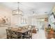 Inviting living room with an open layout, modern lighting, and neutral décor at 1161 Trappers Trail Loop, Davenport, FL 33896