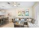 Comfortable living room with a gray sectional couch, ceiling fan, and view into the dining area at 1161 Trappers Trail Loop, Davenport, FL 33896