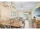 This space offers a comfortable living area with a dining table, sofa, and view to the outdoor patio at 1161 Trappers Trail Loop, Davenport, FL 33896