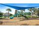 A playground with a shade, slide, and climbing frame at 1161 Trappers Trail Loop, Davenport, FL 33896