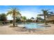 Community pool area features palm trees, lounge chairs and umbrellas for resident's enjoyment at 1161 Trappers Trail Loop, Davenport, FL 33896