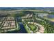 Expansive aerial view of a residential community with picturesque lakes and mature trees at 11908 Delfina Ln, Orlando, FL 32827
