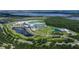 Stunning aerial view of a luxury resort, featuring lush landscapes, serene ponds, and modern architecture at 11908 Delfina Ln, Orlando, FL 32827