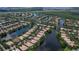 Stunning aerial view of a community featuring winding waterways, lush landscaping, and beautiful homes with tile roofs at 11908 Delfina Ln, Orlando, FL 32827