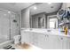 Bathroom featuring a double vanity, sleek glass shower, and modern fixtures at 11908 Delfina Ln, Orlando, FL 32827