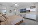 Bedroom with a modern entertainment unit, ceiling fan, and comfortable furnishings at 11908 Delfina Ln, Orlando, FL 32827