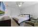 Comfortable bedroom with a plush bed, lounge chairs, and a ceiling fan at 11908 Delfina Ln, Orlando, FL 32827
