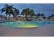 Wide view of the community pool featuring chairs and palm trees, perfect for leisure and recreation at 11908 Delfina Ln, Orlando, FL 32827