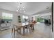 Bright dining area with stylish light fixture opens to the living room, with modern decor and plenty of natural light at 11908 Delfina Ln, Orlando, FL 32827