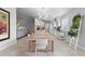 Open dining area with a modern light fixture, seamlessly connected to a bright kitchen and comfortable living space at 11908 Delfina Ln, Orlando, FL 32827
