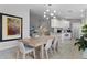 Bright dining area connected to an open kitchen, with plenty of natural light and modern decor, great for entertaining at 11908 Delfina Ln, Orlando, FL 32827