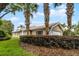 Charming home boasts mature palms, lush landscaping, and a tile roof, all enhancing its curb appeal at 11908 Delfina Ln, Orlando, FL 32827