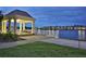 Picturesque lakeside gazebo with seating, offering serene views and a peaceful retreat by the water at 11908 Delfina Ln, Orlando, FL 32827