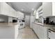 Bright kitchen features white cabinets, countertops, a tiled backsplash, and modern appliances at 11908 Delfina Ln, Orlando, FL 32827
