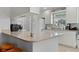 Well-lit kitchen with a breakfast bar, white cabinetry, and modern appliances at 11908 Delfina Ln, Orlando, FL 32827