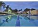 Well lit community lap pool at night, featuring lane markers and a clear, inviting view at 11908 Delfina Ln, Orlando, FL 32827