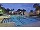 Community lap pool with lane markers for swimming workouts and palm trees for a tropical feel at 11908 Delfina Ln, Orlando, FL 32827