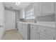 Well-lit laundry room featuring cabinetry, sink, and a window at 11908 Delfina Ln, Orlando, FL 32827