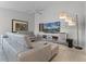 The living room is furnished with an L-shaped sofa and a media unit and features a ceiling fan at 11908 Delfina Ln, Orlando, FL 32827