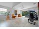 Airy living room with tile flooring, a sliding glass door to patio, and decoratively placed furniture at 11908 Delfina Ln, Orlando, FL 32827