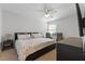 The well-lit bedroom offers a ceiling fan, carpeted floors, and a comfortable bed at 11908 Delfina Ln, Orlando, FL 32827