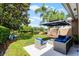 View of patio featuring stylish outdoor furniture overlooking a pond, perfect for enjoying the outdoors at 11908 Delfina Ln, Orlando, FL 32827