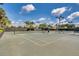Community tennis courts surrounded by trees and lights, offering a recreational space for residents at 11908 Delfina Ln, Orlando, FL 32827