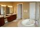 Elegant bathroom showcasing a soaking tub, double vanity, and neutral colors creating a serene atmosphere at 12030 Waterstone Loop Dr, Windermere, FL 34786