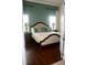 Comfortable bedroom with hardwood floors, a bed with a decorative headboard, and an accent wall at 12030 Waterstone Loop Dr, Windermere, FL 34786