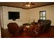 Inviting living room featuring a stone accent wall, hardwood floors, and plush leather seating at 12030 Waterstone Loop Dr, Windermere, FL 34786