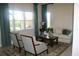 Cozy living room with two chairs, a sofa, an area rug, and large windows at 12030 Waterstone Loop Dr, Windermere, FL 34786