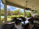 Covered patio with comfortable seating and lush landscaping providing an ideal outdoor relaxation area at 12030 Waterstone Loop Dr, Windermere, FL 34786