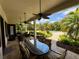 Outdoor patio with a dining table and chairs, ceiling fans, and lush landscaping creating a relaxing space at 12030 Waterstone Loop Dr, Windermere, FL 34786