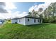 View of the house from the backyard with an expansive lawn and picturesque wooded surroundings at 13068 Sw 36Th Ct, Ocala, FL 34473