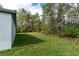 Lush backyard featuring well-maintained grass, mature trees, and a serene, private setting at 13068 Sw 36Th Ct, Ocala, FL 34473
