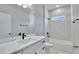 This bathroom has marble tile, a white vanity and a white bathtub at 13068 Sw 36Th Ct, Ocala, FL 34473