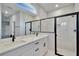 Stylish bathroom featuring double vanities, modern fixtures, and a glass-enclosed shower at 13068 Sw 36Th Ct, Ocala, FL 34473