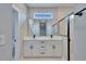 Modern bathroom with a double vanity, black fixtures, large mirror, and glass-enclosed shower at 13068 Sw 36Th Ct, Ocala, FL 34473