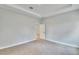 Carpeted bedroom featuring a tray ceiling and an open doorway to another room at 13068 Sw 36Th Ct, Ocala, FL 34473