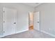 This bedroom has neutral carpet and white doors with black hardware at 13068 Sw 36Th Ct, Ocala, FL 34473