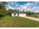 Well-maintained home featuring a lush green lawn and a convenient three-car garage at 13068 Sw 36Th Ct, Ocala, FL 34473